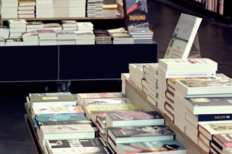 Table displaying stacks of books for sale.