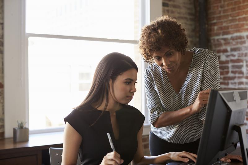 Two women looking at a computer screen