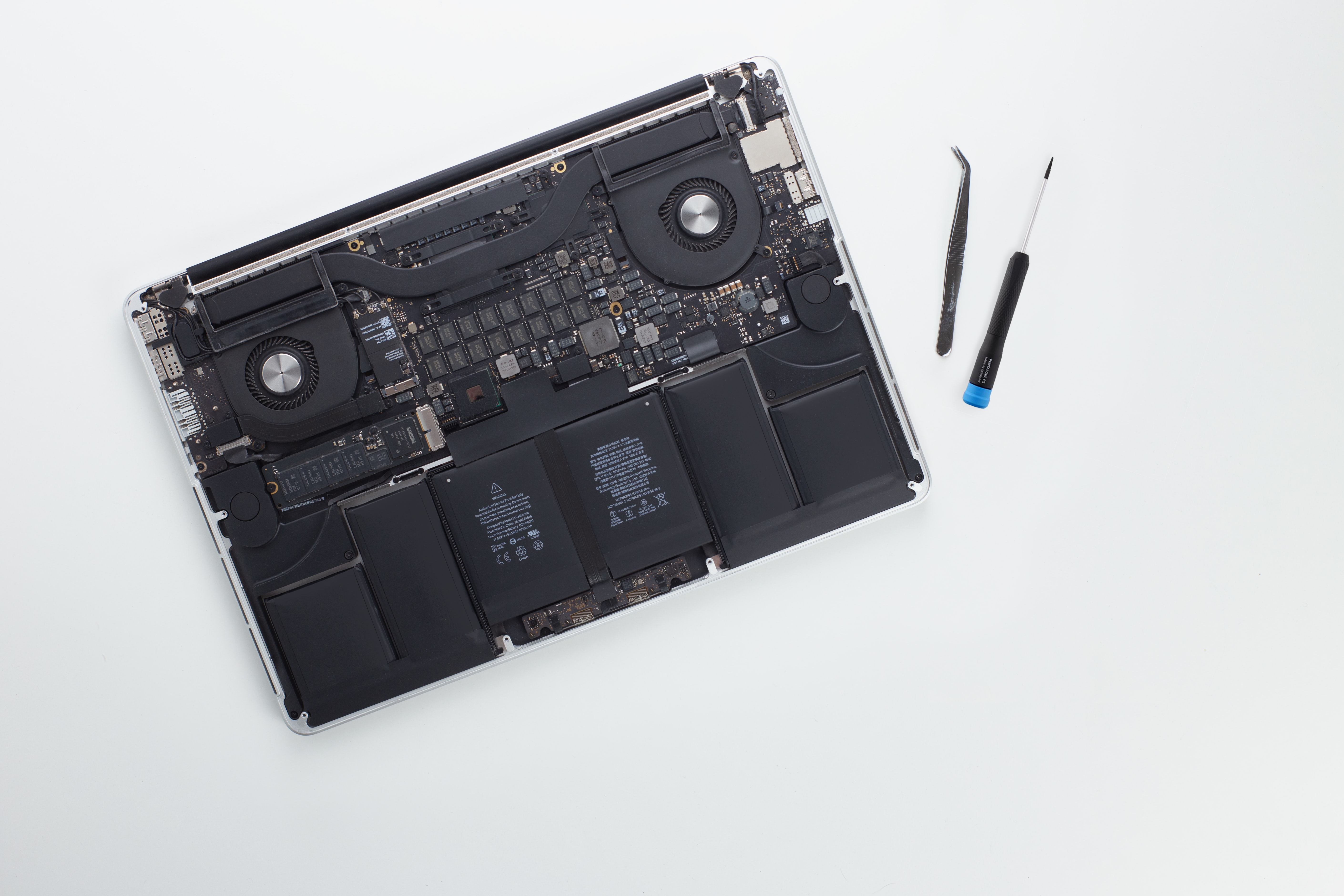 laptop with back removed repair tools